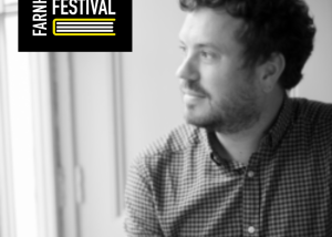 Black and white image of author looking out of window
